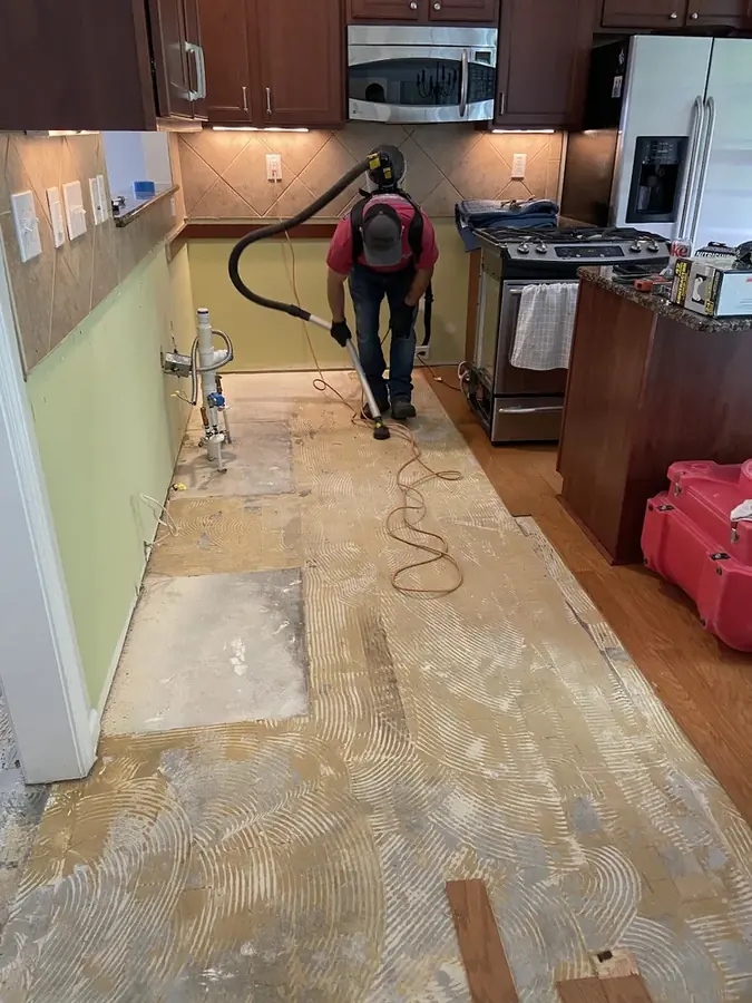 Water leaking from under a dishwasher onto a kitchen floor in a Statham, GA home